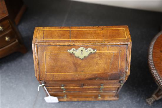A mid 18th century style miniature walnut bureau, 9in., height 9.5in.